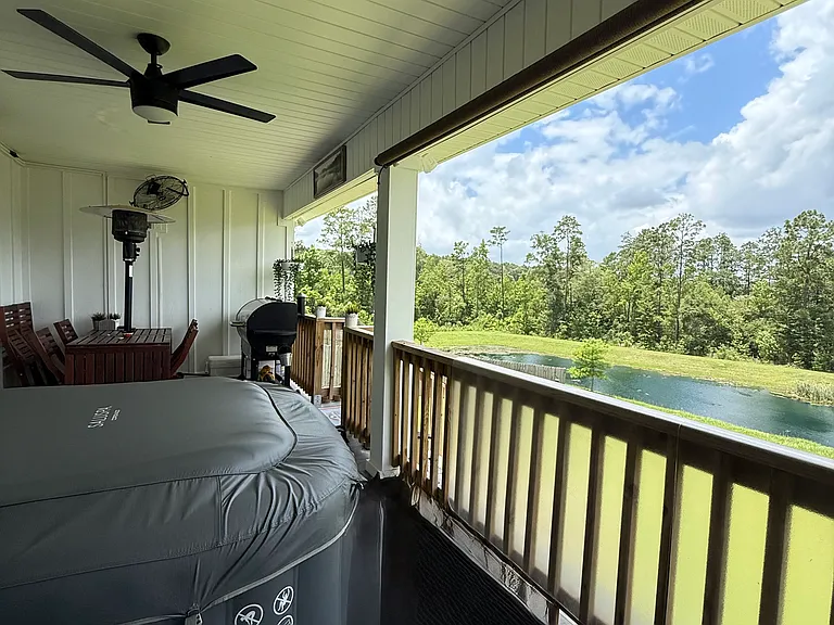 Back porch with ceiling fan and 2 UV Blocking Roller Shade mounted.