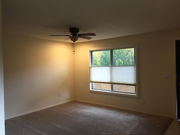 Living room features an overheard fan/light, and up/down blinds that give you privacy where you want and still lets light in.