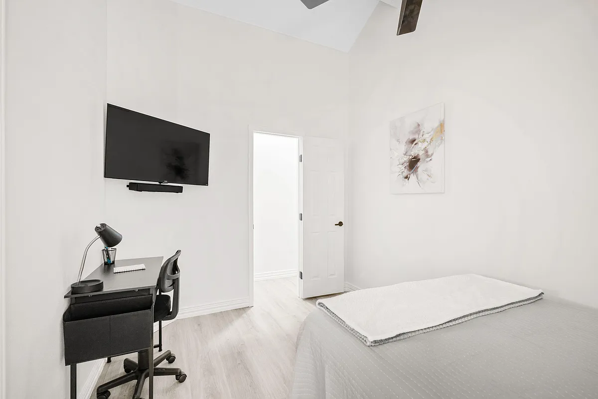 Private bedroom with a bed, work desk and chair, and a wall-mounted TVideal for relaxing and remote work. - Bouldgreen St