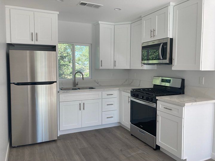 Kitchen with quartz countertops, double sink, all new appliances, and a button switch garbage disposal.