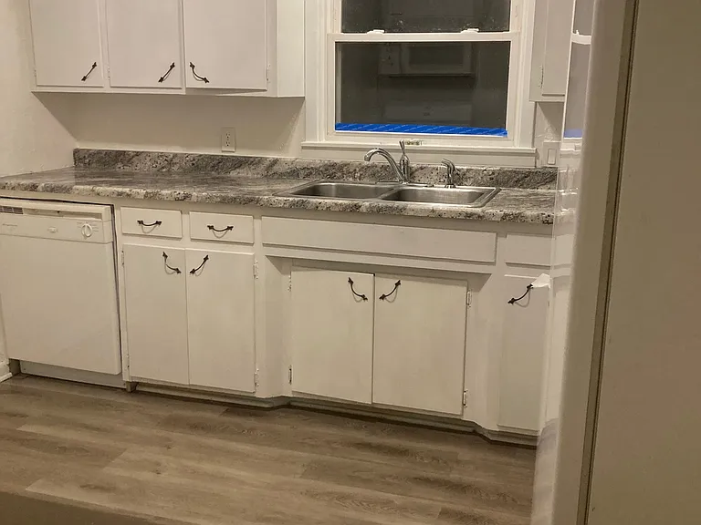 Kitchen- dishwasher, window faces back yard, refrigerator to right.