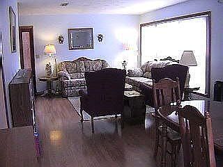 Large living / dining room combo with large windows.