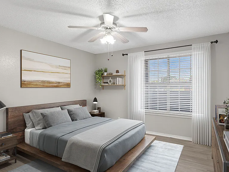 A bedroom with vinyl floors and ceiling fan is shown with mid-century modern furniture and art.