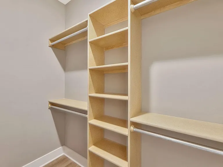 Master closet with built in shelves.