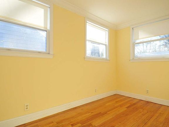 Sunroom with newly re-finished hardwood floors.
