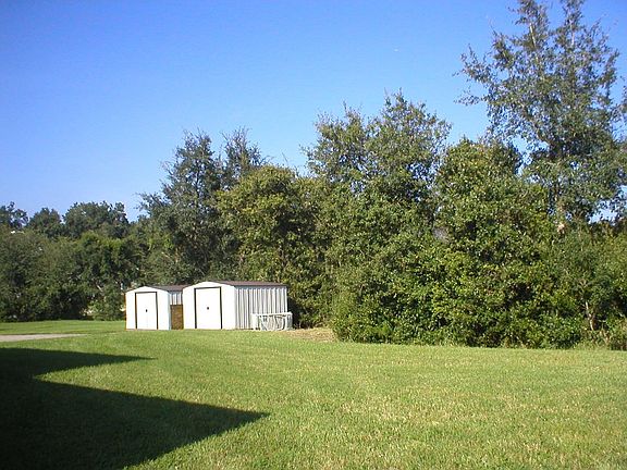 Side of house with utility sheds