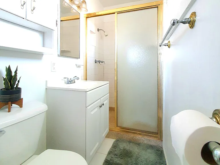 Master's bath with plenty of shelves and vanity
