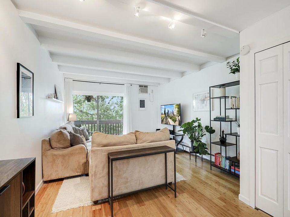 Living room opens up to a private balcony.