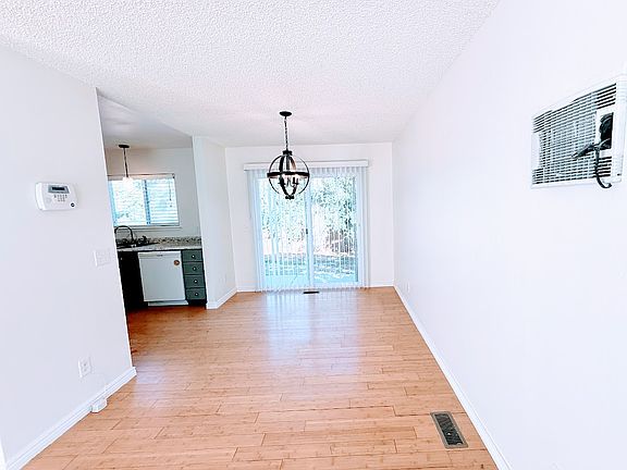 Dining room with sliding glass doors to the backyard. New lighting fixture
