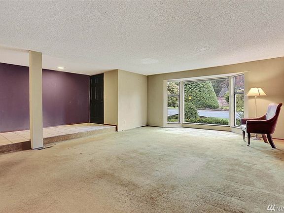 Enjoy entertaining in this large living room. A gorgeous brick fireplace is placed on the wall opposite of window.
