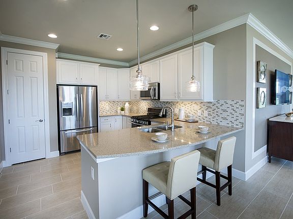 Kitchen with quartz countertops and tile backsplash