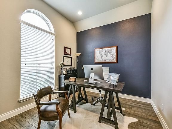 Spacious Family Room Surrounds Fireplace and is Open To Gourmet Island Kitchen.