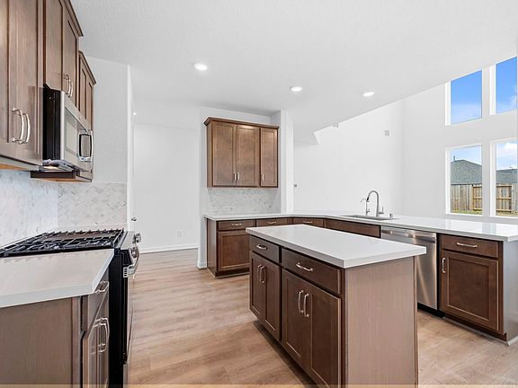 Bright kitchen and family room with the AW Collection Roosevelt and a generous center island, ideal