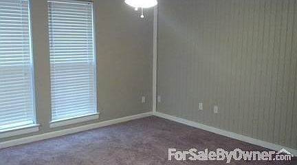 Den
						:
						Spacious carpeted den with two windows and a ceiling fan