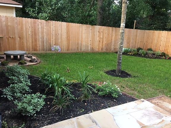 Beautiful landscaping with privacy fence.