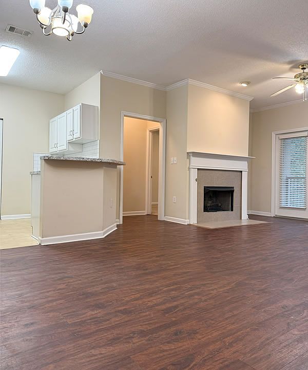 Great room features a gas fireplace and ceiling fan.