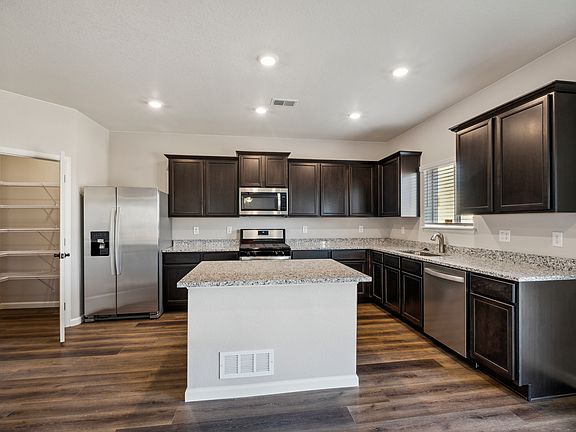 Chef-ready kitchen with an island and granite countertops.