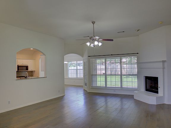 living room w/ wood floors and fireplace