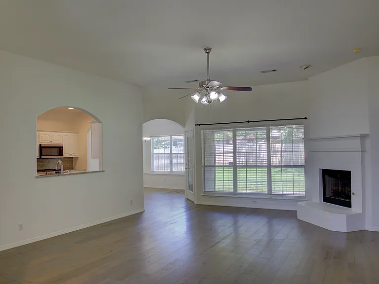 living room w/ wood floors and fireplace