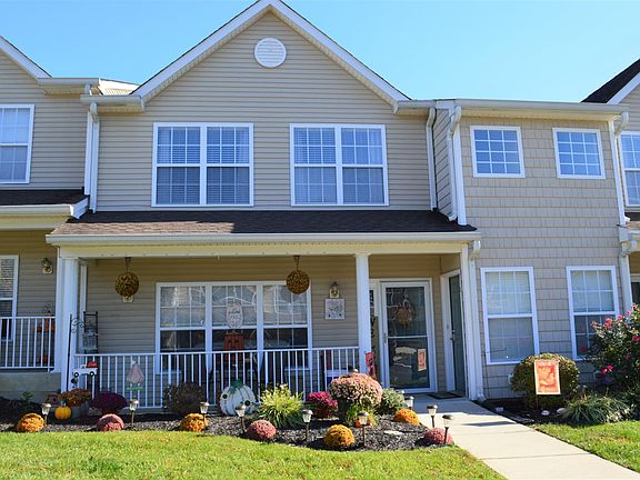 Front of condo is to the right of the decorated lawn