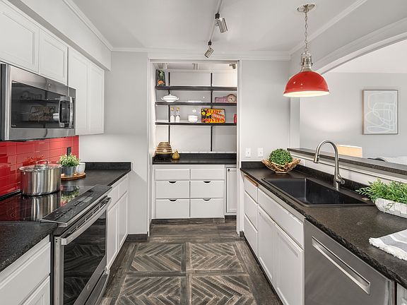 The kitchen was made to cook and entertain. The Pantry has gorgeous glass pocket door.