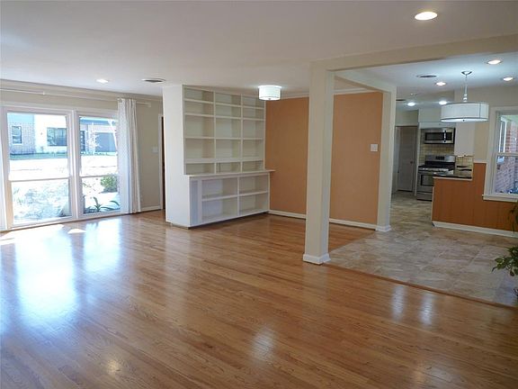 View of living room and study with built-in bookcases. Tiled breakfast area next to kitchen.