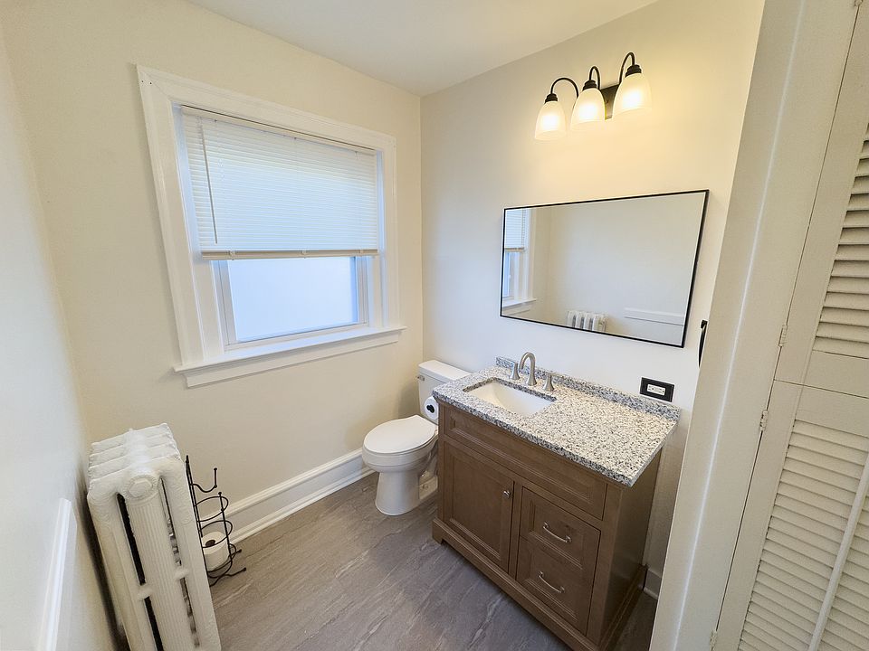 Brand-new bathroom with updated flooring, vanity, toilet, mirror & shower