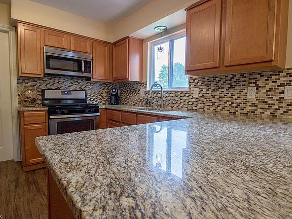 The glamorous granite counters and glass tile splash are sure to make you want to be in the Kitchen creating a delicious dish or