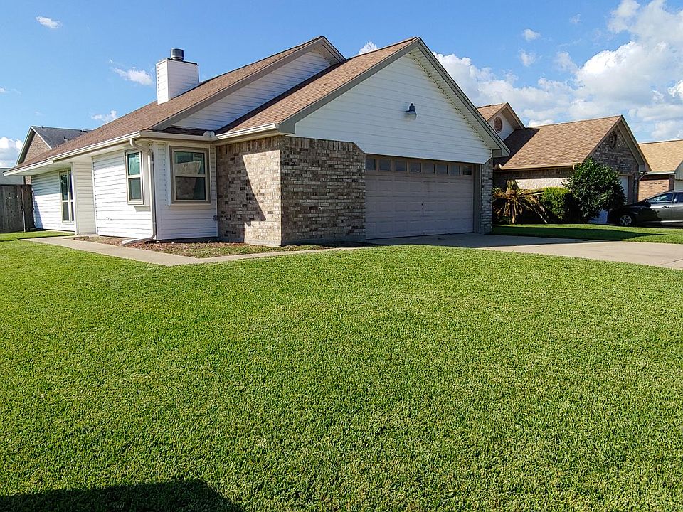 Two bedroom two bath brick on slab features a huge manicured lawn.