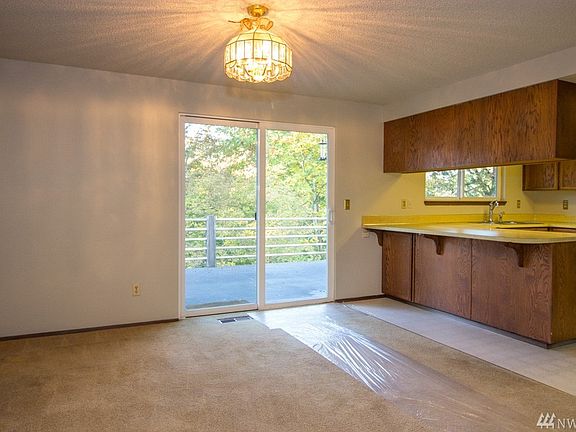 Dining room with slider to deck and kitchen/eating space