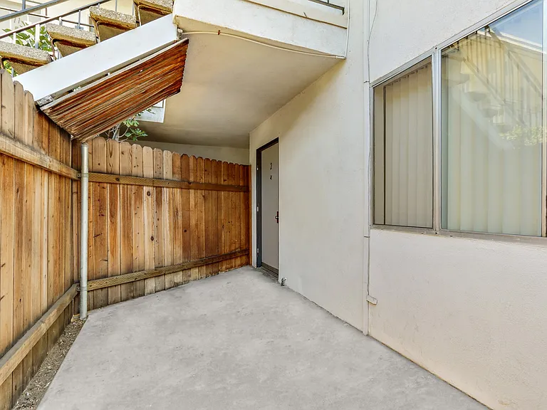 Patio of apartment, wood fence