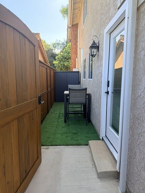 Private entrance with keyless front entry, a turf area, high-top seating, and a storage shed for additional belongings.