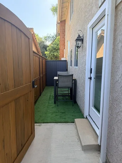 Private entrance with keyless front entry, a turf area, high-top seating, and a storage shed for additional belongings. - 323 Camino De Las Flores #323