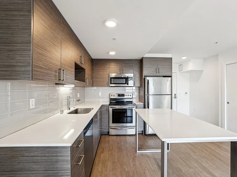 Discover this stunning, contemporary kitchen at 4400 Alaska in Seattle, WA, featuring sleek wood cabinets, pristine white countertops, and full stainless ste...