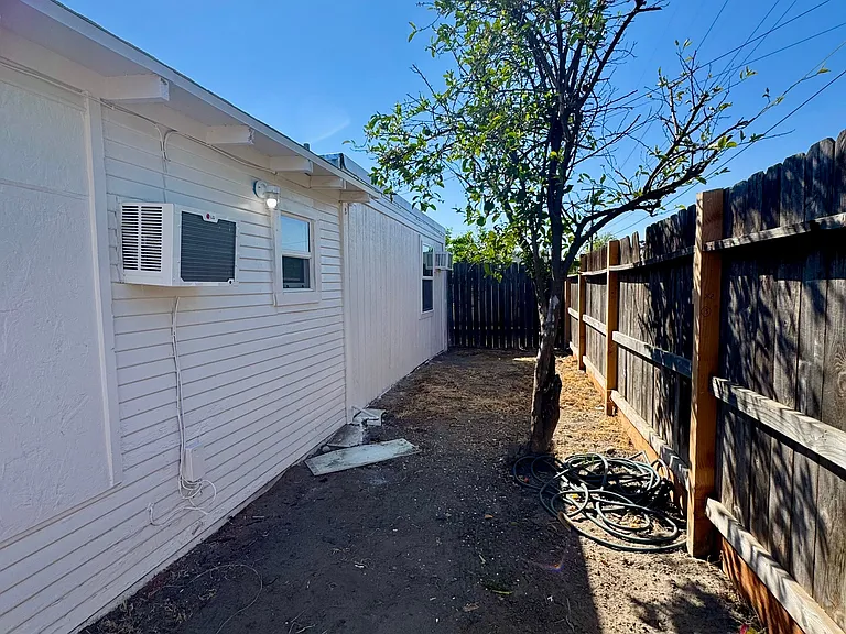 Wide side yard for privacy and space between the house and alley.