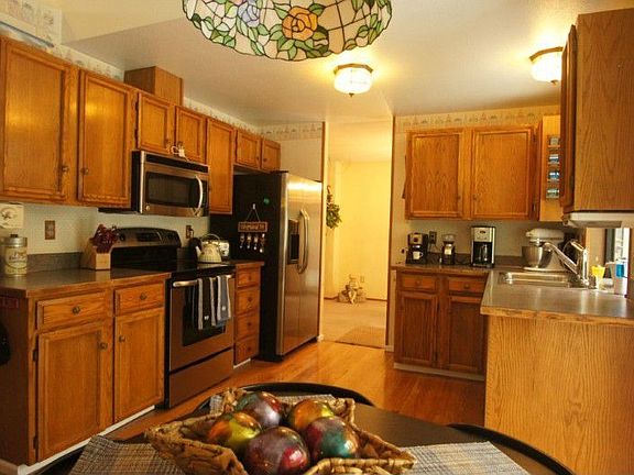 Spacious kitchen with hardwood floors, garden window, stainless steel appliances plus slider to large deck.