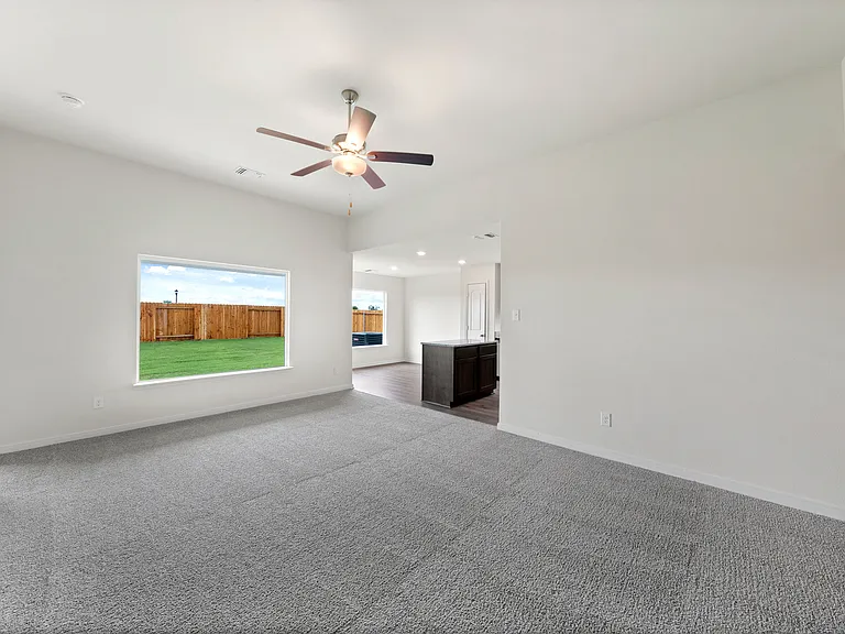 The open layout connects the family room with the kitchen and dining room.