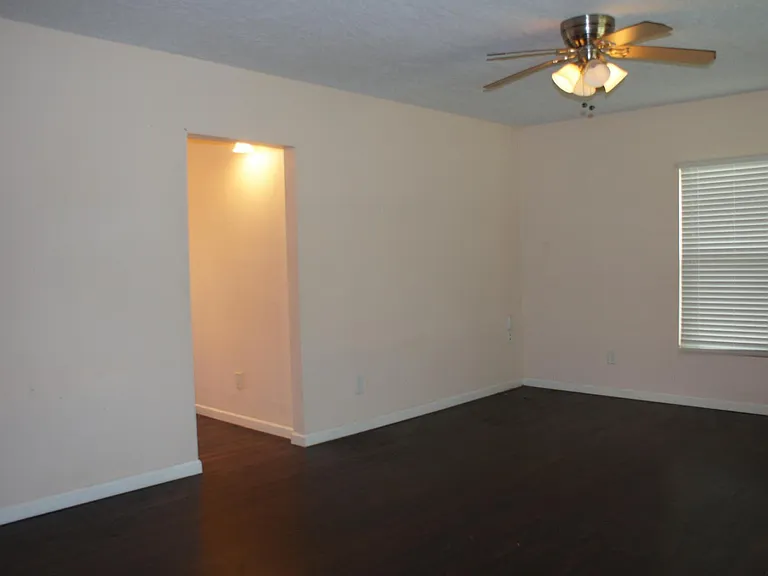 Living room stepping in the front door and looking at the hall toward the kitchen