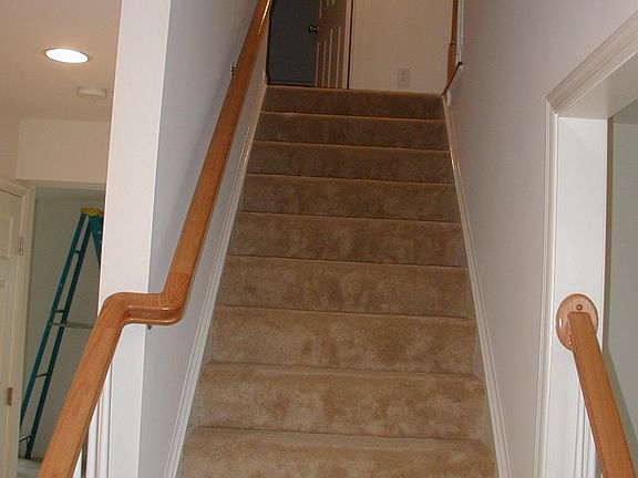 Stairs in foyer leading to 2nd floor bedrooms and bathrooms.