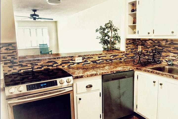 Convection and conventional oven/ range and dishwasher. Bar opening provides entertaining and dining options.