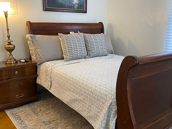 Bedroom #2 Queen bed with lots of storage cabinets in the room.