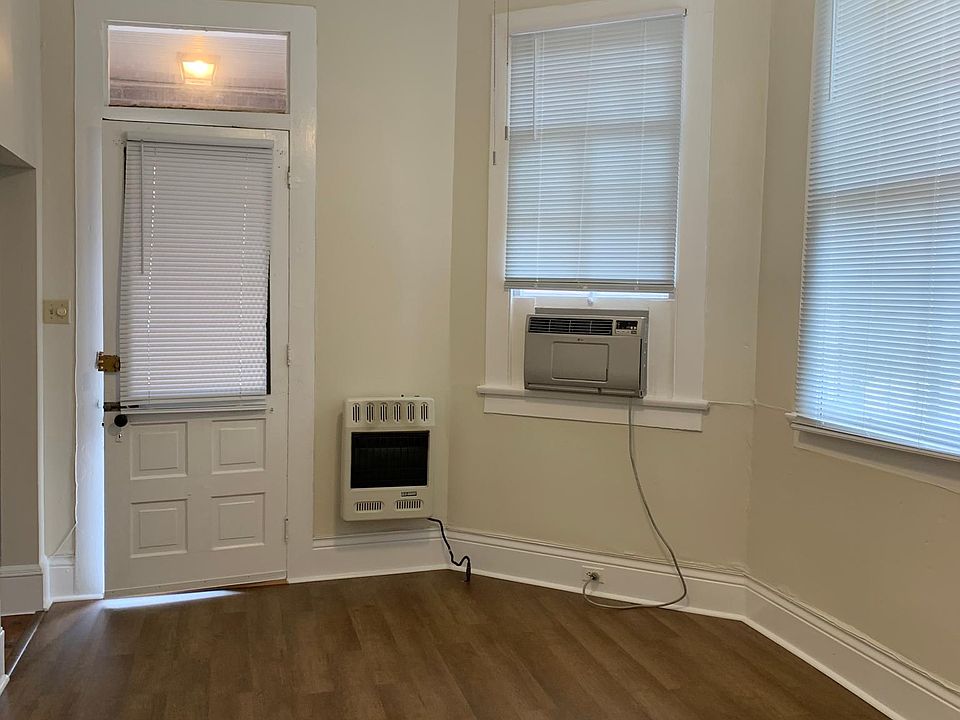 Living room with new floor, paint, ceiling fan and blinds.
