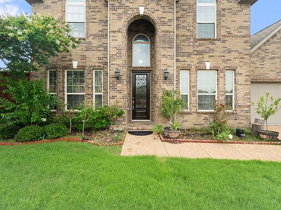 View of exterior entry with brick siding