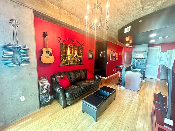 Living room with 60" smart TV. Bedroom and balcony is to the right.