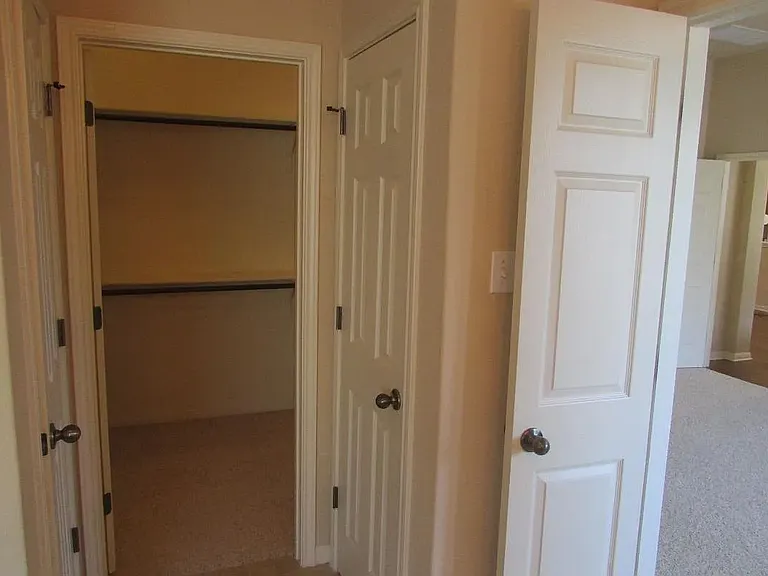 view from the master bathroom: on the right is the master bedroom (hardwood floor now) and on the left, the open door leads into the very spacious walk-in closet, there is a storage space and isolated toilet