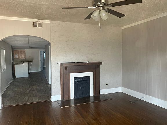 Living room looking into kitchen area. far back door is main level bedroom. Fireplace is decorative only