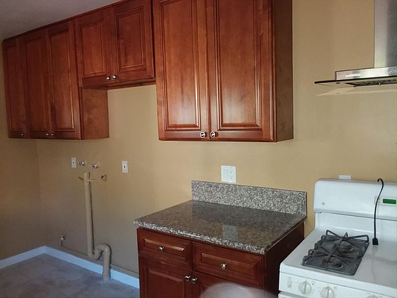 Kitchen has space for refrigerator, washer, dryer.