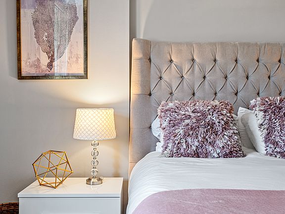 Primary bedroom with white linens
