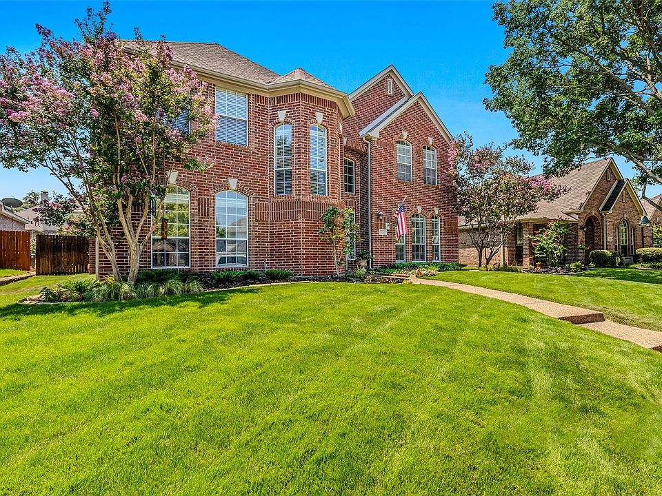 Traditional brick exterior featuring multiple gables and arched windows