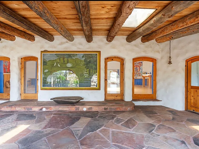 Extra large covered portal with Kiva fireplace and large built-in painting on cloth